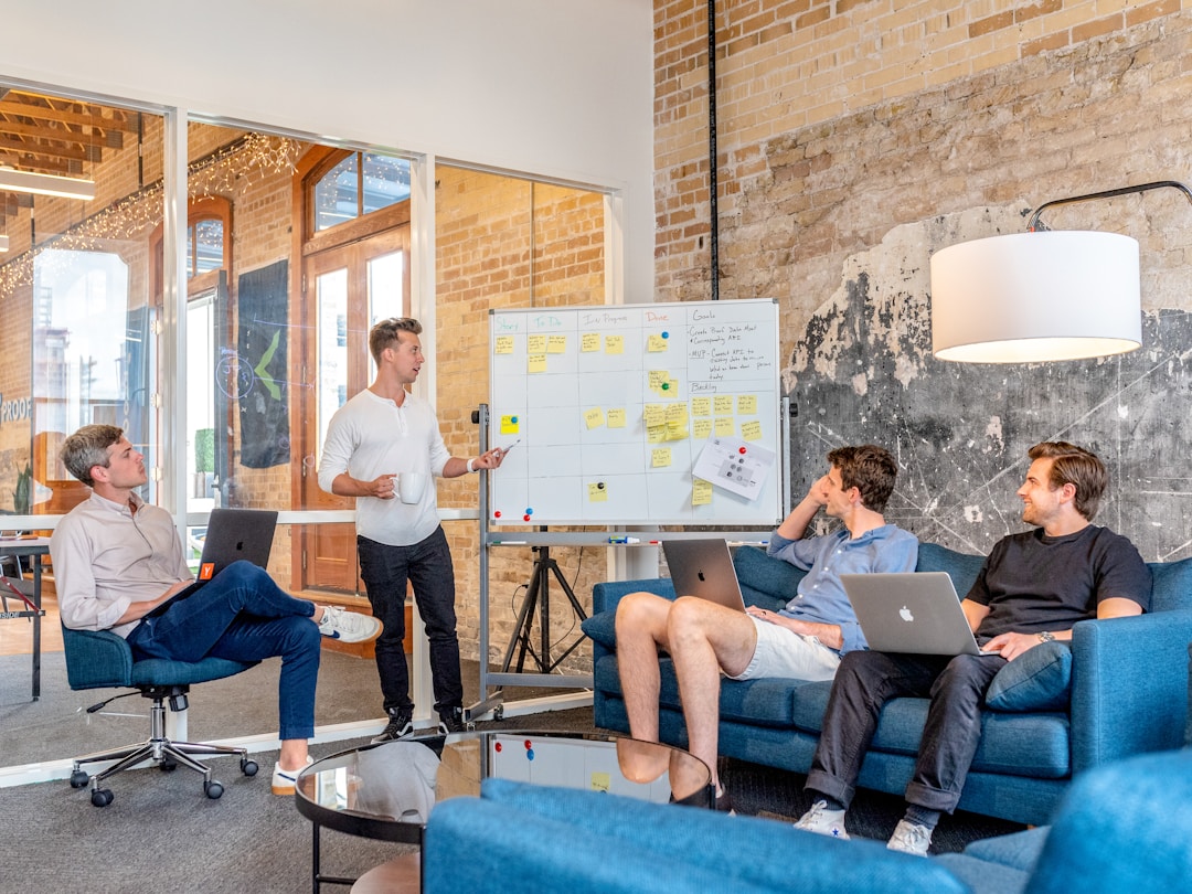 A group of individuals seated on couches in an office, collaborating on the topic of a request for proposal.
